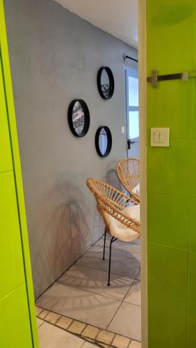 a room with two chairs and a wall with plates at Gîtes chez Daniel "Cevennes 3" in Mars