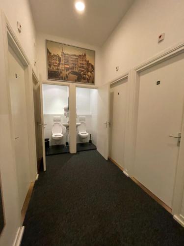 a bathroom with two toilets and a window at Hotel Hortus in Amsterdam