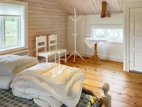 um quarto com uma cama, uma mesa e cadeiras em Holiday home ULRICEHAMN VII em Ulricehamn