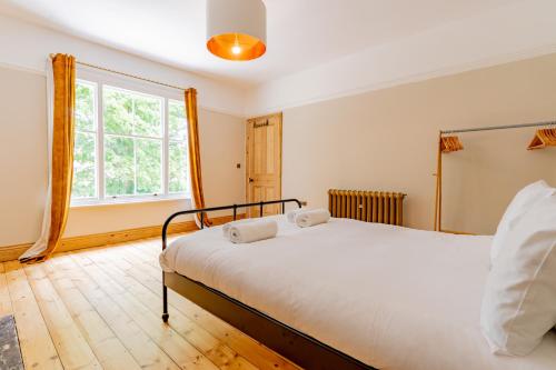 a bedroom with a bed and a window at Felicity's House with Hot Tub! 