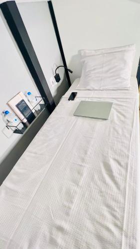 a laptop computer sitting on a bed in a room at URB Hotel in Fortaleza