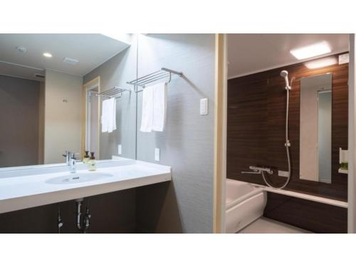 a bathroom with a sink and a shower and a mirror at Hotel Sekisuien - Vacation STAY 44651v in Gujo