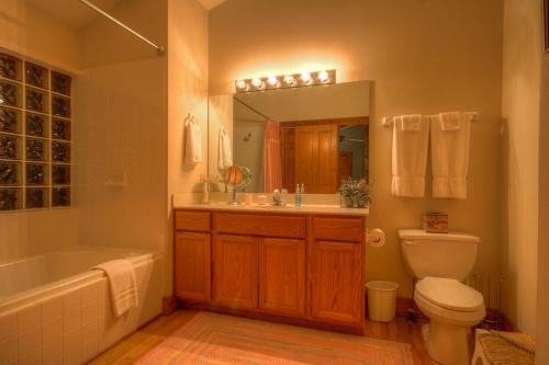 a bathroom with a tub and a toilet and a sink at Sugar Maple at Fiddlestix in Boone