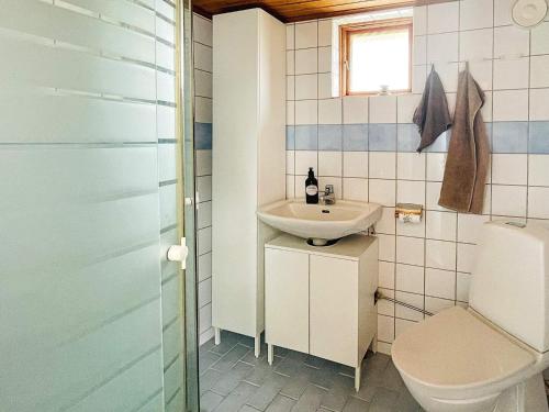a bathroom with a sink and a toilet at Holiday home ÅSTOL 