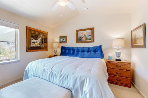 a bedroom with a blue bed and a window at Sweet Retreat at Sweet Water in Hailey