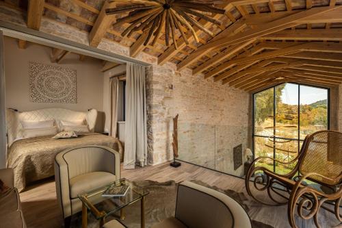 a bedroom with a bed and a large window at Villa La Vinella with heated pool in Buje