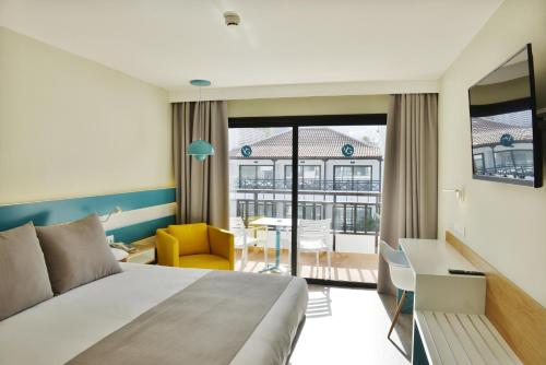 a hotel room with a bed and a desk at Vanilla Garden Boutique Hotel - Adults Only in Playa de las Americas