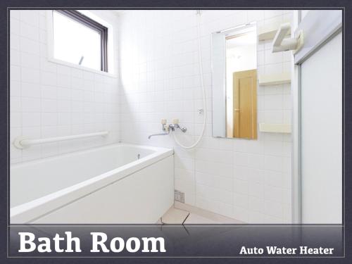 a bathroom with a bath tub and a shower at AirStay Horikiri 402 - Vacation STAY 45433v in Tokyo
