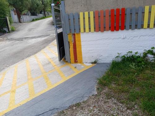 a gate on the side of a road next to a fence at Valta's Room 3 in Paleros
