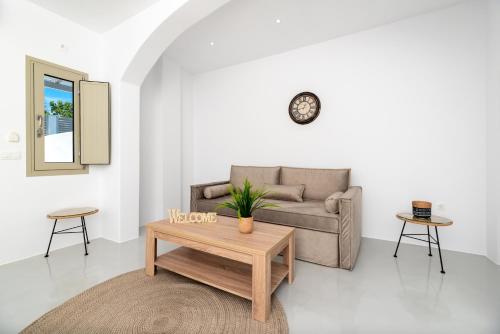 a living room with a couch and a coffee table at Aerenia Luxury Suites in Karterados