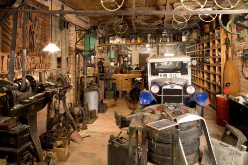 a garage with a truck in the middle of a room at Penzion U Veterána in Slatinice
