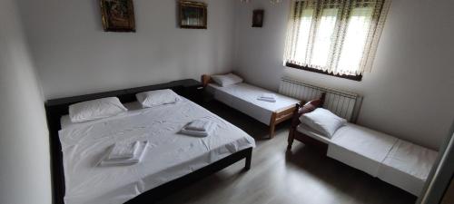 a bedroom with a bed and a couch and a table at House Vidakovic in Kolašin