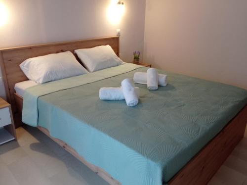 a bedroom with a bed with two towels on it at Hermes Comfort Apartment in Kavos