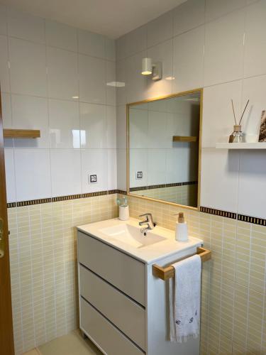 a bathroom with a sink and a mirror at Villa Aloe in Lajares