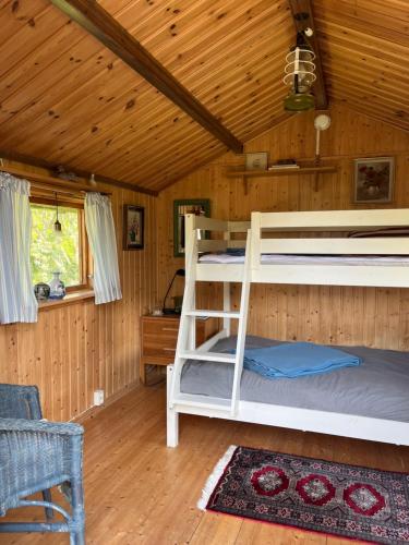 a bedroom with two bunk beds in a cabin at Villa med fantastisk utsikt in Båstad