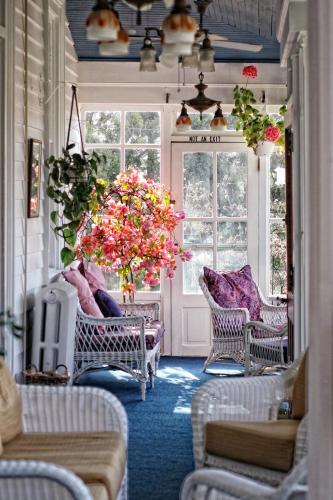 a living room with chairs and a chandelier at Wilbraham Mansion in Cape May