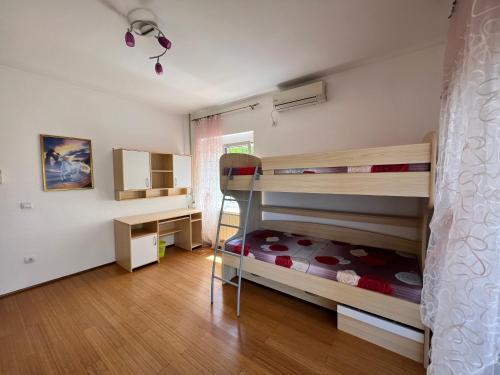 a bedroom with two bunk beds and a desk at House with pool and sea view in Bar