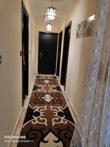 a hallway with a carpet on the floor in a house at مدينتي in Madinaty