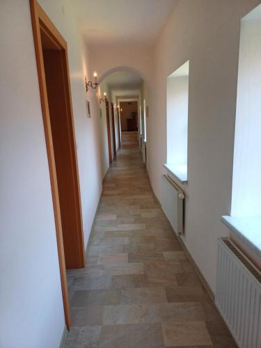 a hallway of a house with a tile floor at Frühstückspension Haus Ebersdorf in Leiben