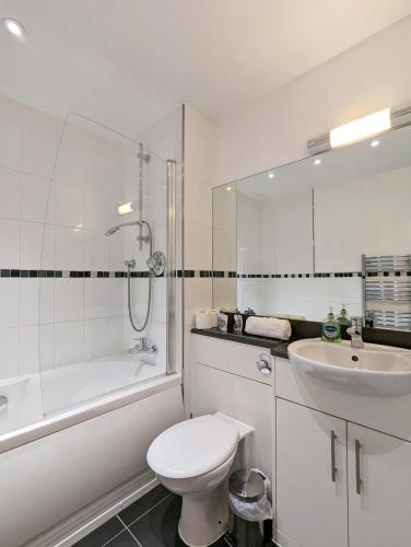a white bathroom with a toilet and a sink at Viva 1 Bed Apartment Birmingham City Centre in Birmingham