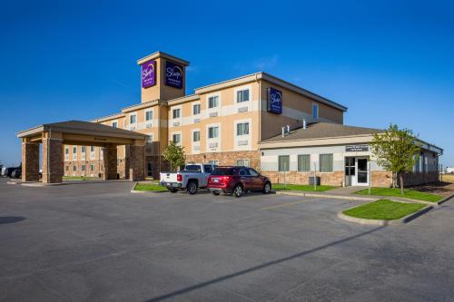a large building with a parking lot in front of it at Sleep Inn & Suites in Colby