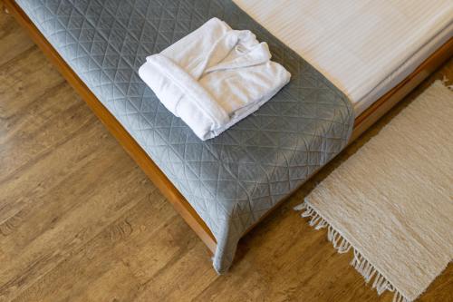 a bed with a white towel sitting on it at Bogolvar Retreat Resort in Antonovka