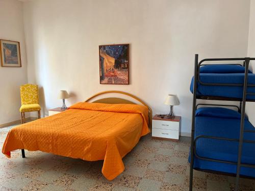 a bedroom with a bed and two bunk beds at La Casa del Professore in Nicotera Marina