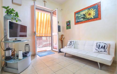 a living room with a white couch and a television at Vulcano in Pozzallo