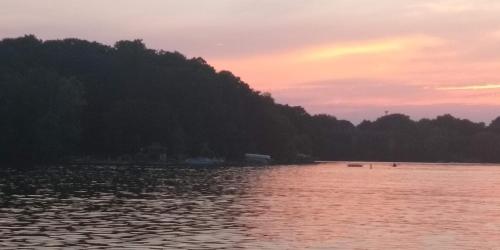 a body of water with a sunset in the background at StoneWall House in Lake Elmo