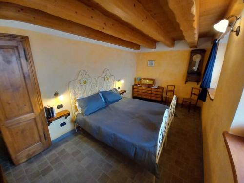 a bedroom with a large bed with a blue comforter at Chalet la terrazza vista lago in Bellano