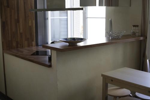 a kitchen with a counter with a bowl on it at La parenthèse in Dijon