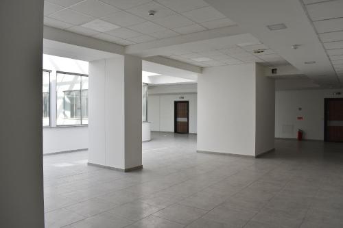 an empty room with white columns and a tile floor at Ohrid Sunlight in Ohrid