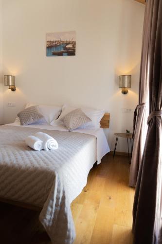 a bedroom with two towels on a bed at Holiday Home Rakova in Gornje Selo