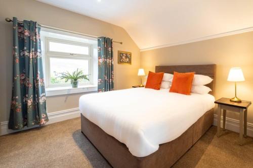 a bedroom with a large bed and a window at Adams Townhouse in Dingle