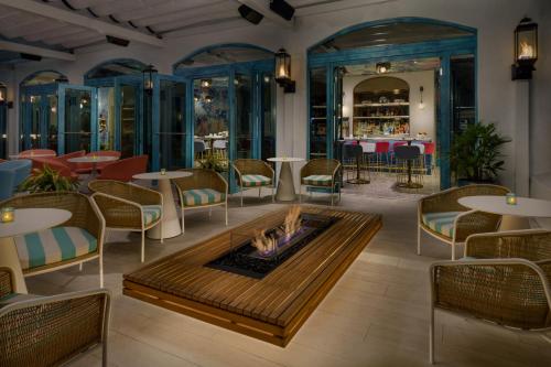 a restaurant with a fire pit and tables and chairs at AC Hotel St Petersburg Downtown in St. Petersburg