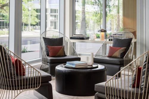 a room with three chairs and a table and windows at AC Hotel St Petersburg Downtown in St Petersburg