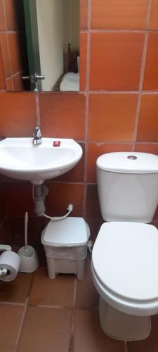 a bathroom with a toilet and a sink at Hotel Casa San Rafael in Villa de Leyva