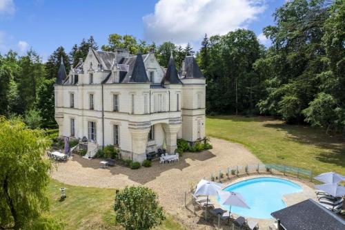 an estate with a swimming pool in front of it at Château de Mont-Félix in Saint-Jean-Saint-Germain