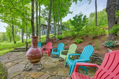 a group of colorful chairs sitting in a yard at On 22 Acres Cullowhee Craftsman Home with Mtn Views in Cullowhee