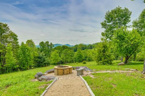 a fire pit in the middle of a field at On 22 Acres Cullowhee Craftsman Home with Mtn Views in Cullowhee