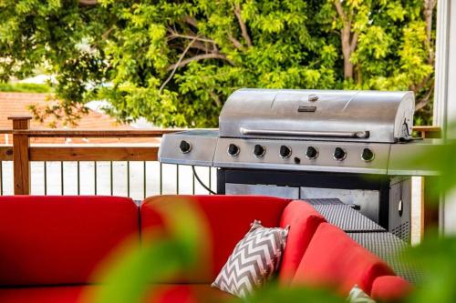 a grill sitting next to a red couch at Villa Anthea in Willemstad