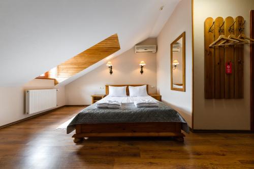 a bedroom with a bed and a staircase at Bogolvar Retreat Resort in Antonovka