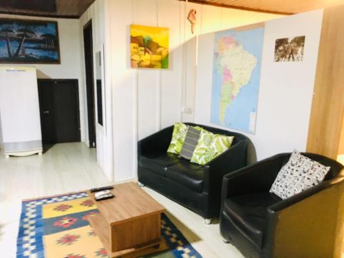 a living room with a couch and a coffee table at Nossa Casa Novo Hamburgo in Novo Hamburgo