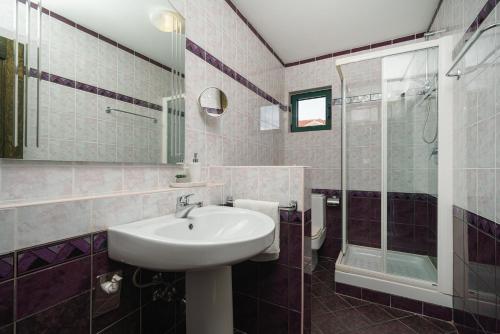 a bathroom with a sink and a shower at Villa David in Vodice