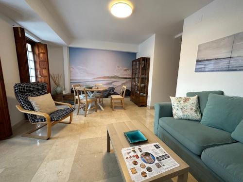 a living room with a blue couch and a table at Porta da Vila by Oktheway in Puentedeume