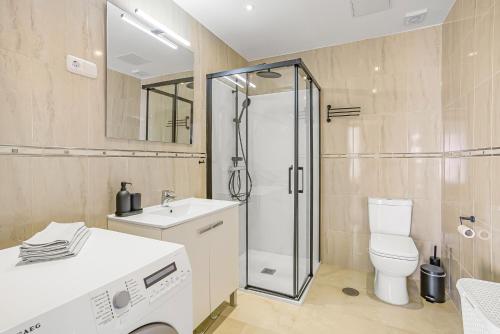 a bathroom with a shower and a toilet and a sink at Villa Torremimosas in Fuengirola