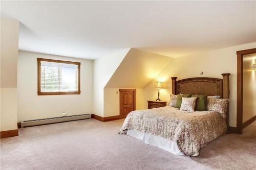 a bedroom with a large bed and a window at Mountain Falls in Stowe