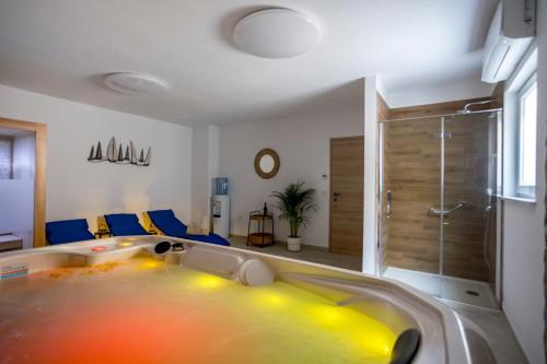 a large yellow tub in a bathroom with a shower at Luxury Villa Petros in Malinska
