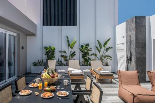 a dining room with a table with food on it at Maison Aqua Suite with Private mini pool jacuzzi in Hersonissos
