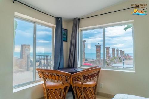 a room with two chairs in front of a window at Rancho Percebu Beach Studio 4 in Don Pancho